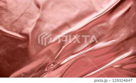 Shimmering rose gold foil texture background with soft reflections, elegant and luxurious feel 129324647