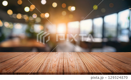 Wooden tabletop with soft bokeh effect in modern office interior, warm lighting creates inviting atmosphere Wooden tabletop with soft bokeh effect in modern office interior, warm lighting creates inviting atmosphere 129324870
