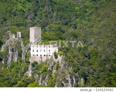 Medieval Castle Burgruine Rauhenstein in Baden, Austria in Alpine Forest - Scenic Ruins on Rocky Cliff Medieval Castle Burgruine Rauhenstein in Baden, Austria in Alpine Forest - Scenic Ruins on Rocky Cliff 129325042