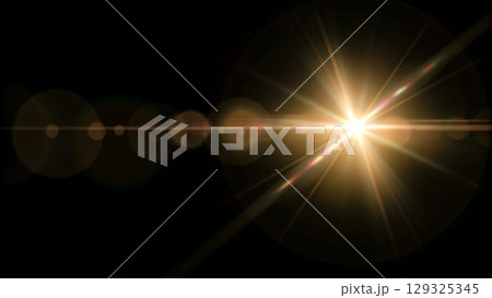 A bright light flare with multiple rays and circular lens flares on a black background 129325345
