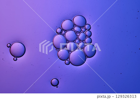 Bubbles in shampoo or shower gel. Texture on a purple background. Bubbles in shampoo or shower gel. Texture on a purple background. 129326313