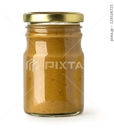Glass jar containing mustard with gold lid on white background Glass jar containing mustard with gold lid on white background 129326725
