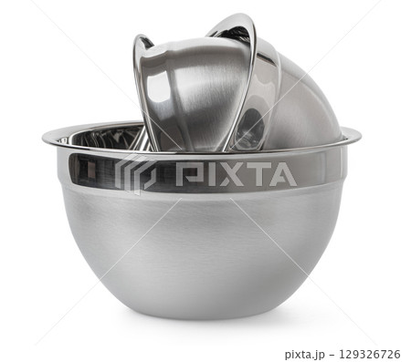Shiny stainless steel mixing bowl on white surface 129326726