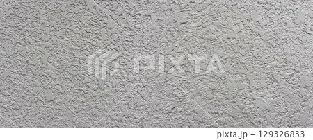 Gray concrete wall showing rough textured surface creating intriguing pattern 129326833