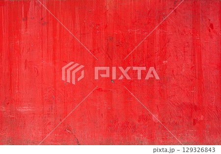 Red painted concrete wall showing signs of ageing and wear, creating textured background Red painted concrete wall showing signs of ageing and wear, creating textured background 129326843