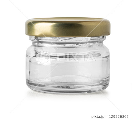 Small empty glass jar with golden lid isolated on white background Small empty glass jar with golden lid isolated on white background 129326865