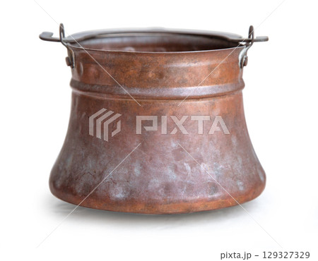 Old copper pot showing oxidation with handles on white background 129327329