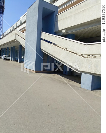 Brutalist concrete building in a minimalist style in gray and blue colors representing urban architecture and mid-century design with copy space Brutalist concrete building in a minimalist style in gray and blue colors representing urban architecture and mid-century design with copy space 129327510
