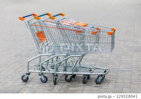Shopping carts lined up on a concrete surface Shopping carts lined up on a concrete surface 129328041