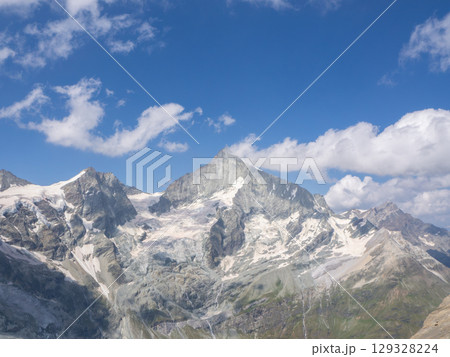 Mettelhorn, Switzerland - August 24th 2024: Impressive view from the summit towards Weisshorn peak. Mettelhorn, Switzerland - August 24th 2024: Impressive view from the summit towards Weisshorn peak. 129328224