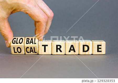 Global or local trade symbol. Concept words Global trade Local trade on beautiful wooden blocks. Beautiful grey background. Businessman hand. Business Global or local trade concept. Copy space 129328353