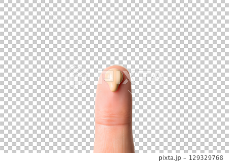 Close-up of fingertip testing liquid foundation, beauty product texture showcase 129329768