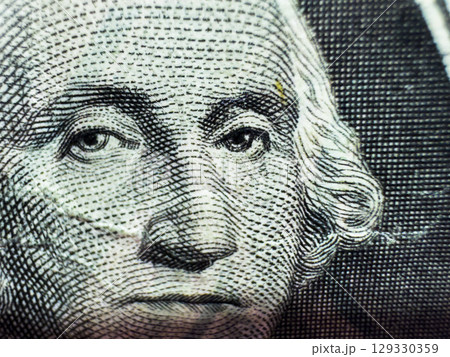 George Washington's disgruntled face on a crumpled dollar bill in close-up macro in gray George Washington's disgruntled face on a crumpled dollar bill in close-up macro in gray 129330359
