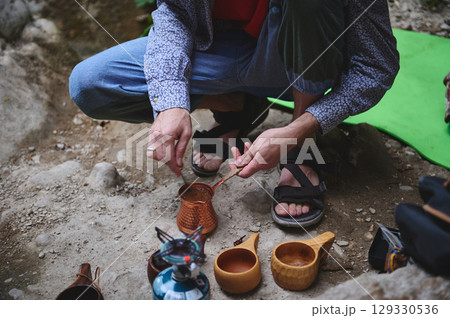 Outdoor Cooking Scene Showcasing Traditional Methods in a Natural Setting Outdoor Cooking Scene Showcasing Traditional Methods in a Natural Setting 129330536
