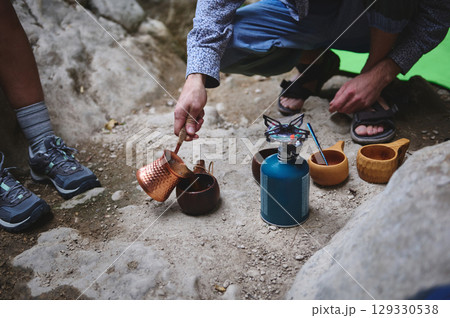 Camping Scene with Copper Pot and Outdoor Cookware in Rustic Mountain Setting 129330538