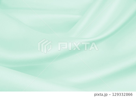 Smooth elegant green silk or satin luxury cloth texture as abstract background. Luxurious background design 129332866