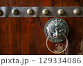 Intricate metal knocker on wooden door in DuJiangYan featuring t 129334086