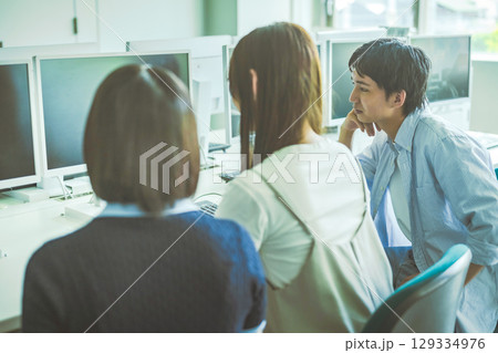 　パソコン教室でグループ作業をする学生たち 129334976