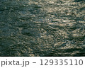 Flowing waters of the Min River reflecting sunlight in DuJiangYa 129335110