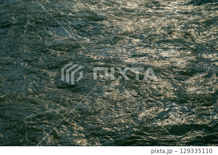 Flowing waters of the Min River reflecting sunlight in DuJiangYa 129335110