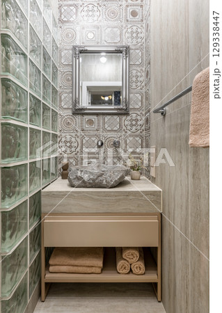 Narrow Rustic Bathroom with Stone Sink and Framed Mirror 129338447