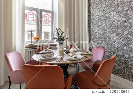 Modern Dining Room with Velvet Chairs and Elegant Tableware 129338642