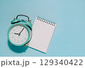 Alarm Clock and Notepad on Blue, Time Management and Planning 129340422