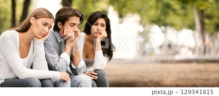 Boredom. Three Bored Friends Sitting Sad On Bench In Park Spending Time Together In Park Outdoors. Selective Focus Boredom. Three Bored Friends Sitting Sad On Bench In Park Spending Time Together In Park Outdoors. Selective Focus 129341815