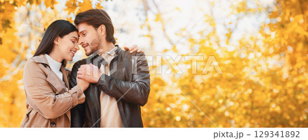 Emotional young lovers cuddling during romantic date at autumn forest, copy space 129341892