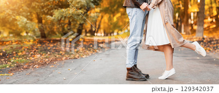 Cropped of girl standing on her toes and kissing her boyfriend over forest background Cropped of girl standing on her toes and kissing her boyfriend over forest background 129342037
