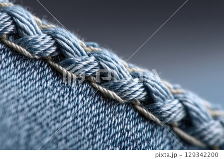 Zigzag stitching detail along a denim seam showcasing textile craftsmanship 129342200