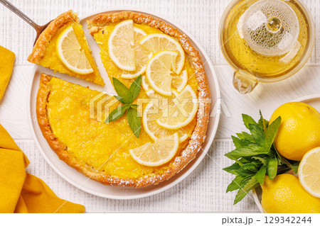 Delicious lemon tart with golden crust and smooth, glossy lemon filling Delicious lemon tart with golden crust and smooth, glossy lemon filling 129342244