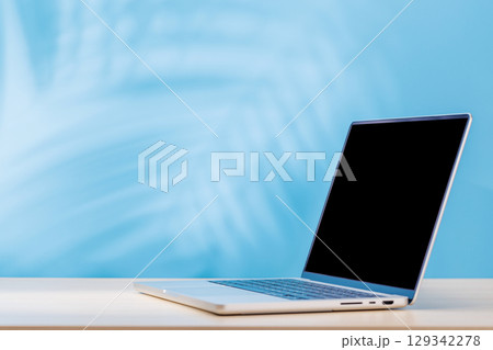 Laptop with a blank screen placed on a table Laptop with a blank screen placed on a table 129342278