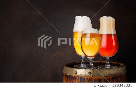 A selection of various beer glasses filled with different types of beer A selection of various beer glasses filled with different types of beer 129342326