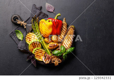 Assorted grilled vegetables including bell peppers, zucchini, eggplant, and asparagus 129342331