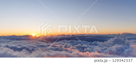 Sunset above the clouds with warm colors and soft light Sunset above the clouds with warm colors and soft light 129342337