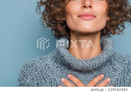 Young woman with closed eyes and hand on chest Young woman with closed eyes and hand on chest 129342465