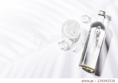 Crystal-clear glasses filled with chilled water and ice cubes 129342516