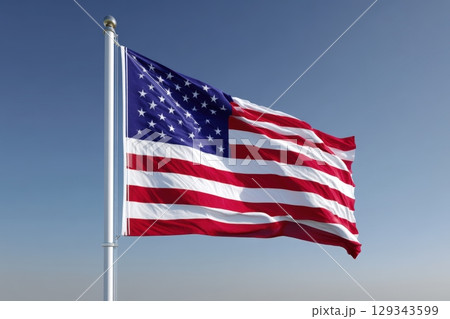 Flag of the United States waving under a clear blue sky during daytime Flag of the United States waving under a clear blue sky during daytime 129343599
