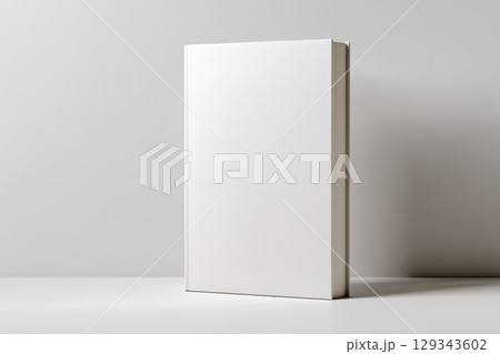 Blank book standing upright on a minimalist shelf in a modern interior space 129343602