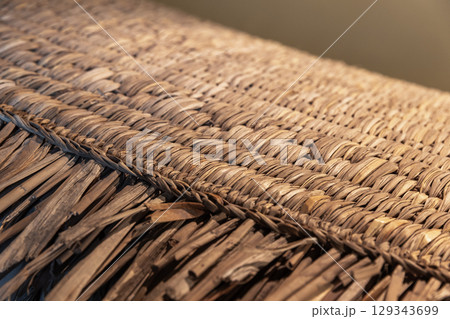 Close-Up of a Woven Thatch Surface Displaying Detailed Craftsmanship Close-Up of a Woven Thatch Surface Displaying Detailed Craftsmanship 129343699