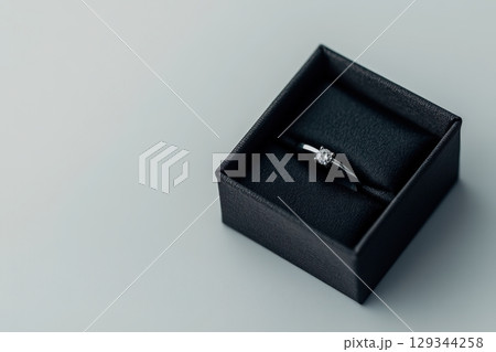 Elegant diamond ring displayed in a black box on a soft surface 129344258
