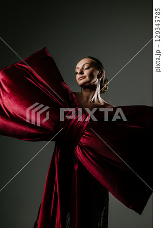 Elegant Woman Posed with Large Red Velvet Bow Elegant Woman Posed with Large Red Velvet Bow 129345785