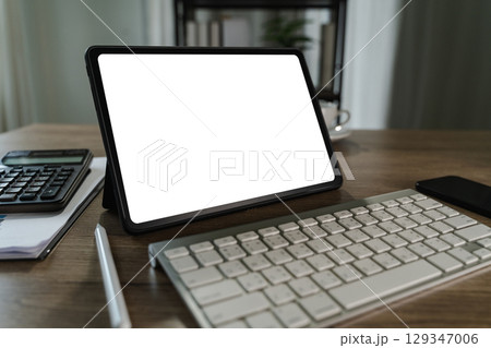 A businessman holds a mockup. iPad digital tablet with blank screen Mockup replaces your design mockup in the office. A businessman holds a mockup. iPad digital tablet with blank screen Mockup replaces your design mockup in the office. 129347006