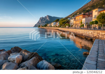 Sunrise illuminating san vito lo capo coastline with monte monaco in background 129348212