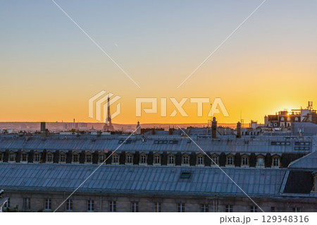 View of Paris and Eiffel Tower and rooftops from above. Beautiful sunset over Paris, France 129348316