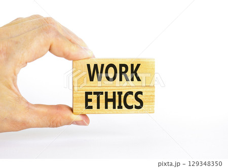 Work ethics symbol. Concept words Work ethics on beautiful wooden block. Beautiful white table white background. Businessman hand. Business and Work ethics concept. Copy space. 129348350