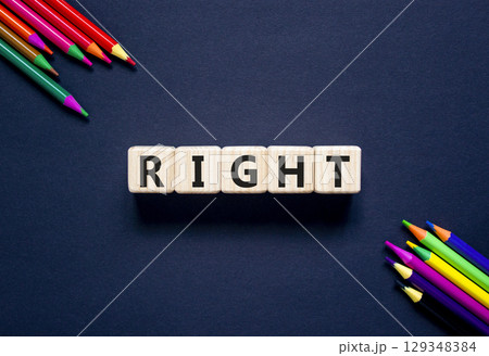 Right symbol. Concept word Right on beautiful wooden blocks. Beautiful black table black background. Beautiful colored pencils. Business lifestyle right concept. Copy space. 129348384