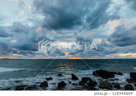landscape on the sea and sunset on the horizon with clouds 129348804