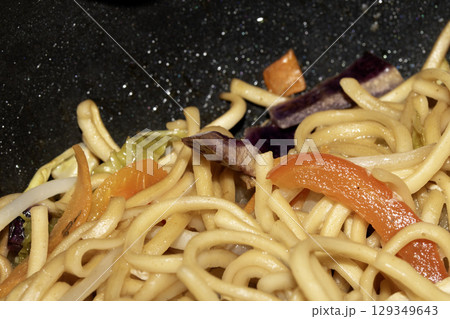 Close up of home made stir fry noodles being cooked 129349643